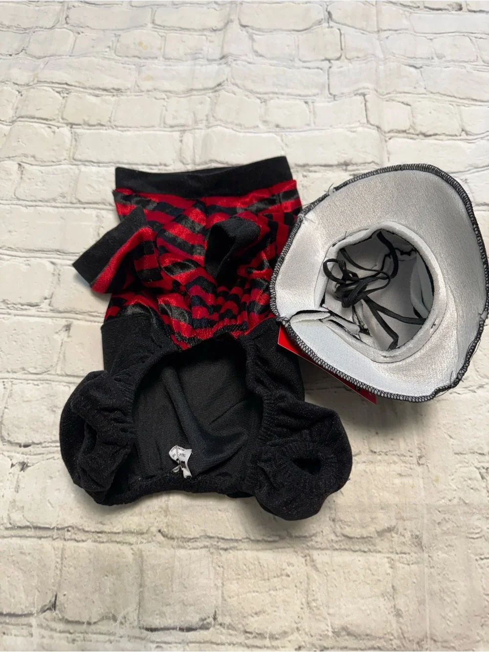 Pet Warrior Dog striped red and white shirt and black pants custome. Halloween c